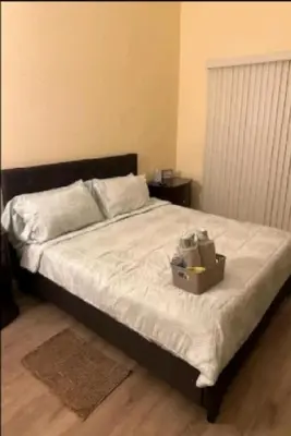 a bed with a box sitting on top of it at Be our Guest Hm Tampa in Palmdale