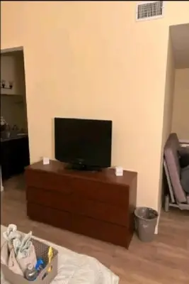 a flat screen tv sitting on top of a dresser at Be our Guest Hm Tampa in Palmdale