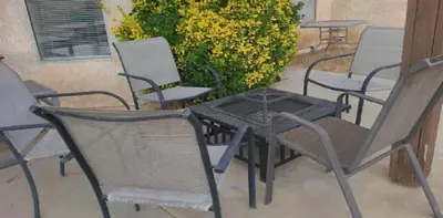 a group of chairs and a table on a patio at Be our Guest Hm Tampa in Palmdale