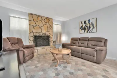 a living room with a couch and a table at High Desert Dream on the Fairway WiFi Smart TVs in Victorville