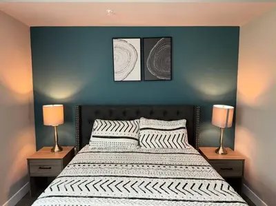 a bedroom with a large bed with two lamps at Spacious and Modern 3 bedroom 2 unit in Los Angeles