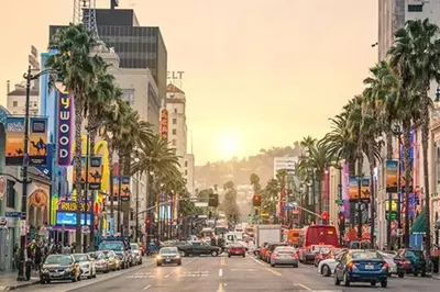 a busy city street filled with cars and palm trees at Spacious and Modern 3 bedroom 2 unit in Los Angeles