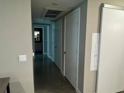 a hallway of an empty room with a door and a hallway at Spacious and Modern 3 bedroom 2 unit in Los Angeles