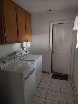 a kitchen with a stove and a sink and a door at Lyons lovely house in Hesperia