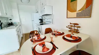 a kitchen with a table with plates and wine glasses at Oceanfront 2BR 2BA with Stunning View 333 in Redondo Beach