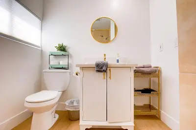 a bathroom with a toilet and a mirror at Cozy Private Studio in Granada Hills Near CSUN, Universal in Mission Hills