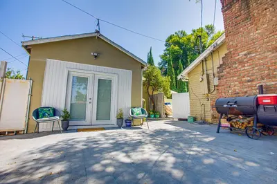a house with a garage with chairs in front of it at Cozy Private Studio in Granada Hills Near CSUN, Universal in Mission Hills