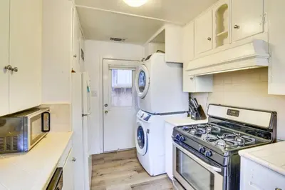a kitchen with a stove and a washer and dryer at The Twin Pines Chalet, 2 min to Village, BBQ in Big Bear Lake