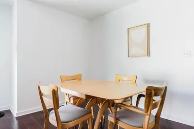 a dining room with a wooden table and chairs at Blueground Mid-Wilshire pool nr retail LAX-1266 in Los Angeles