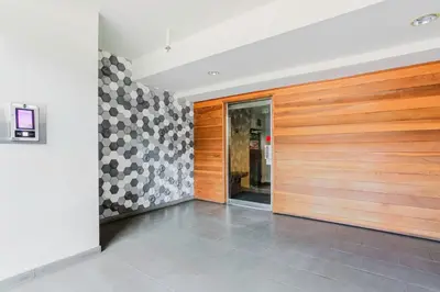 a hallway with a wooden door and a tile floor at Blueground Mid-Wilshire pool ac nr retail LAX-1265 in Los Angeles
