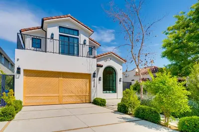 a white house with a brown garage at Villa Camellia in Los Angeles