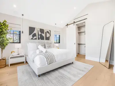 a white bedroom with a white bed and a rug at Villa Camellia in Los Angeles