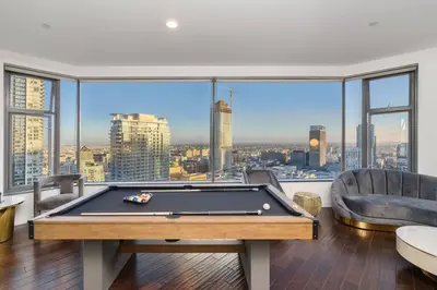 a living room with a pool table and a large window at Downtown LA with the breathtaking view 2 bedrooms and parking space in Los Angeles