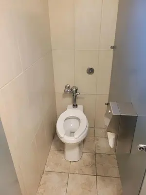 a bathroom with a toilet in a stall at Randolph Hotel in Huntington Park