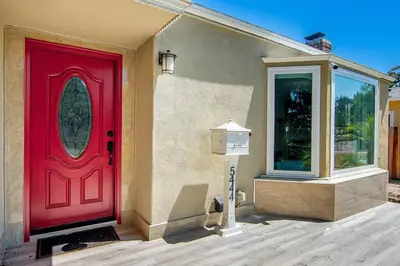 a red door on the side of a house at 3-Bedroom Sherman Oaks House Near Universal Studios in Los Angeles