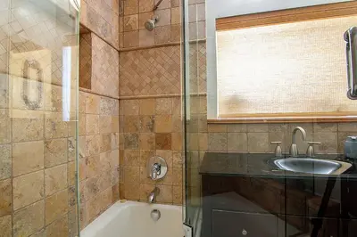 a bathroom with a tub and a sink and a shower at 3-Bedroom Sherman Oaks House Near Universal Studios in Los Angeles