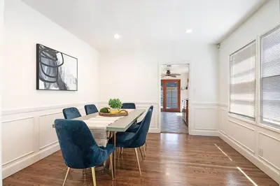 a dining room with a table and blue chairs at 3-Bedroom Sherman Oaks House Near Universal Studios in Los Angeles