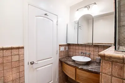 a bathroom with a sink and a mirror at 3-Bedroom Sherman Oaks House Near Universal Studios in Los Angeles