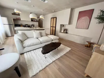 a living room with a white couch and a rug at 2 Bedroom Tulum Oasis in Hollywood in Los Angeles