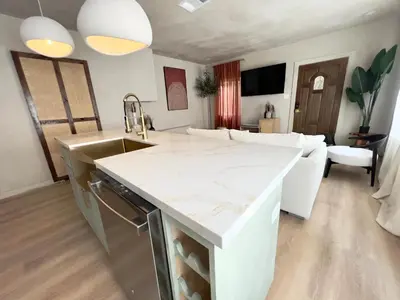 a kitchen and living room with a white counter top at 2 Bedroom Tulum Oasis in Hollywood in Los Angeles
