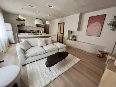 a living room with a white couch and a kitchen at 2 Bedroom Tulum Oasis in Hollywood in Los Angeles