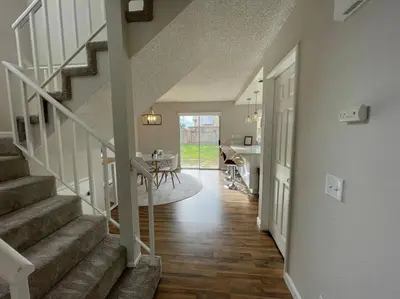 a hallway of a home with stairs and a dining room at Pristine & Smart freshly remodeled house! in Lancaster