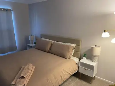 a bedroom with a large bed with two pillows at Pristine & Smart freshly remodeled house! in Lancaster