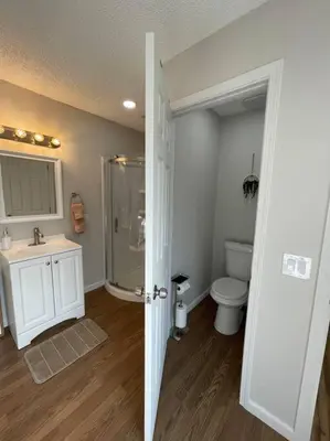 a bathroom with a shower and a sink and a toilet at Pristine & Smart freshly remodeled house! in Lancaster