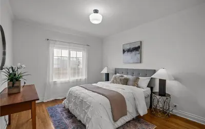 a white bedroom with a large bed and a desk at Modern 2-Bedroom in Santa Moinca Area Close to UCLA in Los Angeles