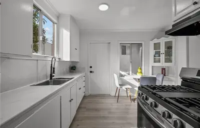 a white kitchen with a sink and a stove at Modern 2-Bedroom in Santa Moinca Area Close to UCLA in Los Angeles