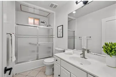 a white bathroom with a toilet and a shower at Modern 2-Bedroom in Santa Moinca Area Close to UCLA in Los Angeles