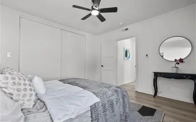 a white bedroom with a ceiling fan and a bed at Modern 2-Bedroom in Santa Moinca Area Close to UCLA in Los Angeles