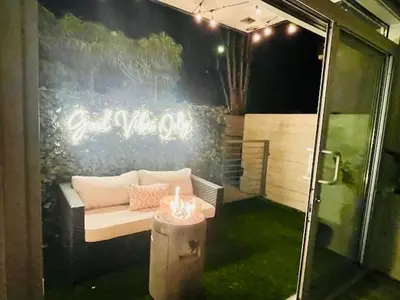 a room with a couch and a table with a candle at Luxury Open BD w Pool, Parking, & WD 133 in Los Angeles