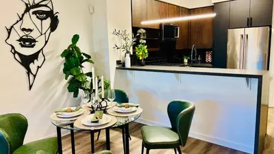 a dining room with a table and green chairs at Luxury Open BD w Pool, Parking, & WD 133 in Los Angeles