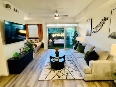 a living room with a couch and a table at Luxury Open BD w Pool, Parking, & WD 133 in Los Angeles