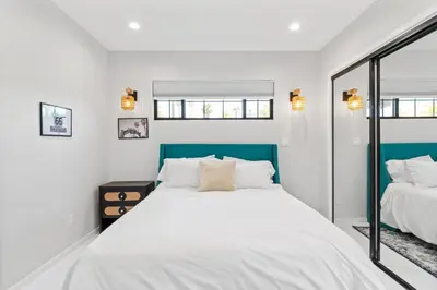 a bedroom with a large white bed and two windows at Bohemian Beach ## in Los Angeles