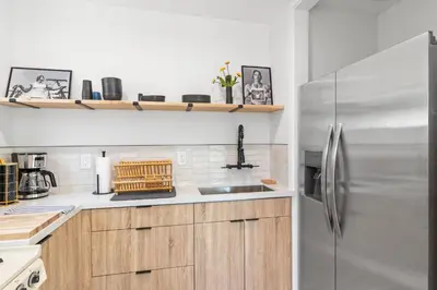 a kitchen with wooden cabinets and a stainless steel refrigerator at Bohemian Beach ## in Los Angeles