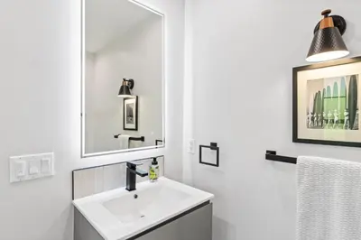a white bathroom with a sink and a mirror at Bohemian Beach ## in Los Angeles