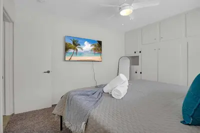 a bedroom with a bed and a painting on the wall at 6th Haven, Arcade, King Bed, Games, 1 Mile to Beaches in Long Beach