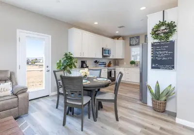 a kitchen and dining room with a table and chairs at Comfy and Stylish 4 Bathrooms 26 in Ridgecrest
