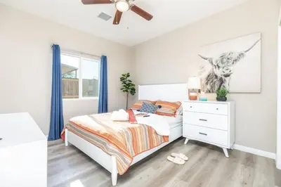 a white bedroom with a bed and a dresser at Refreshing and Spotless 4 Bathrooms 22 in Ridgecrest