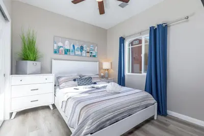a bedroom with a bed and a dresser and a window at Refreshing and Spotless 4 Bathrooms 22 in Ridgecrest