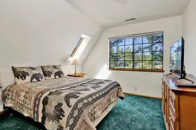 a bedroom with a bed and a window at Breezy estate #114 in Big Bear Lake