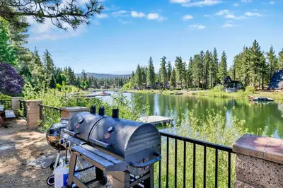 a grill sitting next to a body of water at Breezy estate #114 in Big Bear Lake