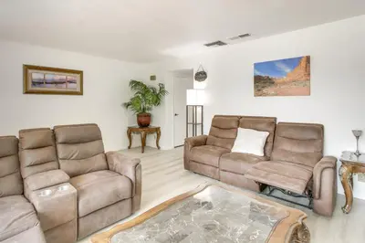 a living room with two couches and a table at Pet-Friendly Ridgecrest Home Near OHV Trails! in Ridgecrest