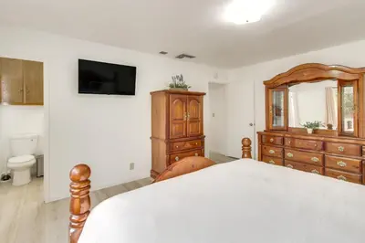 a bedroom with a bed and a dresser at Pet-Friendly Ridgecrest Home Near OHV Trails! in Ridgecrest