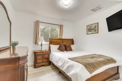 a bedroom with a bed and a dresser and a television at Pet-Friendly Ridgecrest Home Near OHV Trails! in Ridgecrest