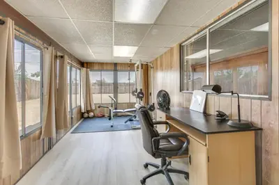 an office with a desk and chairs in a room at Pet-Friendly Ridgecrest Home Near OHV Trails! in Ridgecrest