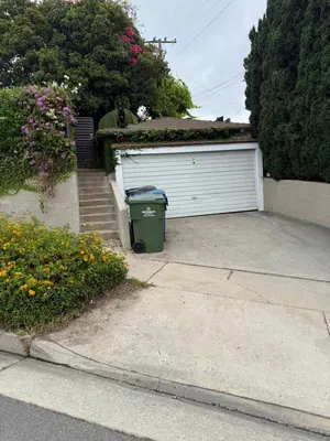 a garage with a garbage can in the driveway at Inglewood Forum and Sofi park and walk private room in Inglewood