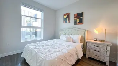 a bedroom with a white bed and a window at Stunning Hollywood Sign View in Los Angeles